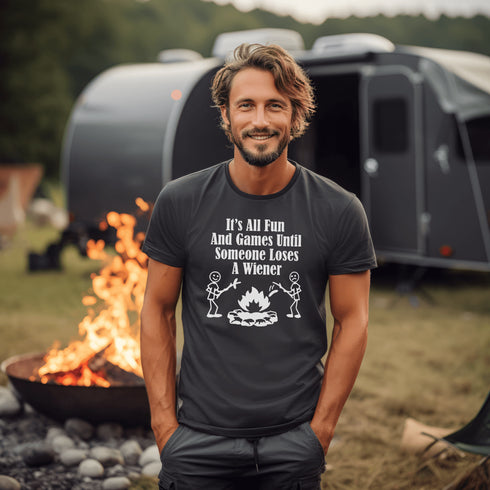 Our Camping tee features two adorable stick figure people roasting wieners over a cozy campfire. And with the hilarious slogan "It's All Fun & Games Until Someone Loses A Wiener," you'll be the life of the party at any camping trip!